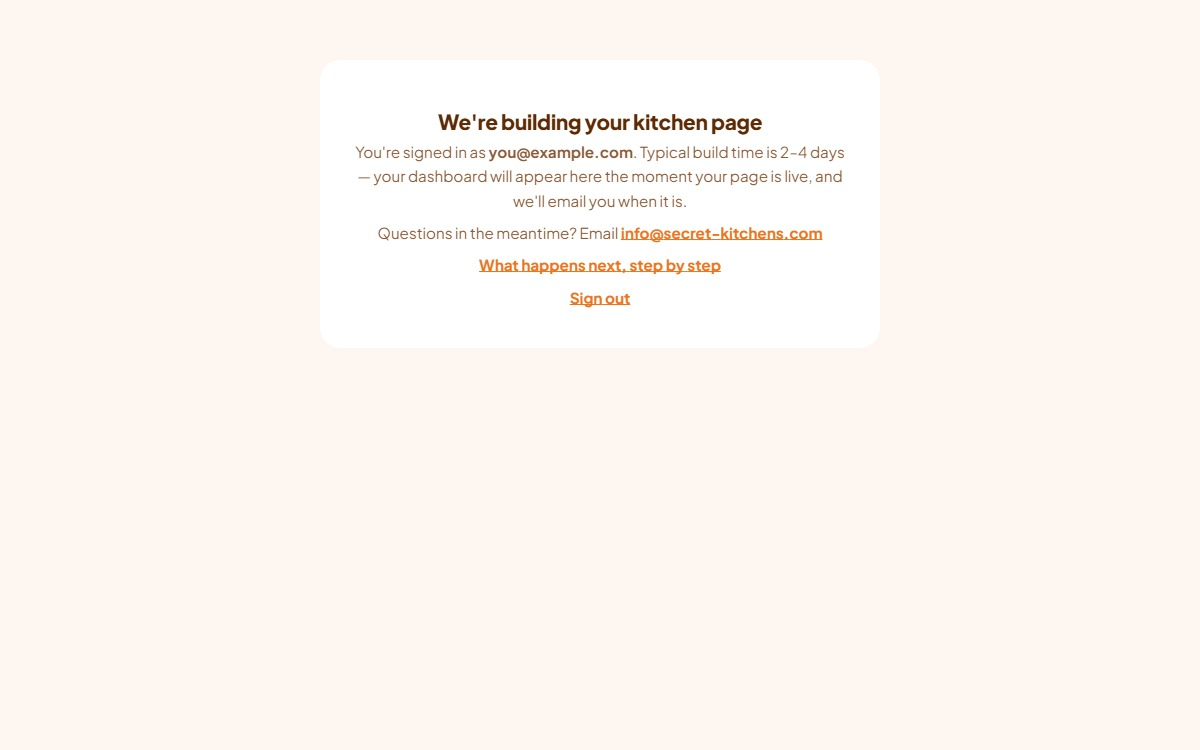 The dashboard holding screen shown before a kitchen is attached: a card reading We're building your kitchen page, with the signed-in email and a sign-out link.